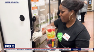 Fox 5 screen share of a Hope Atlanta volunteer working in the Women's Community Kitchen.